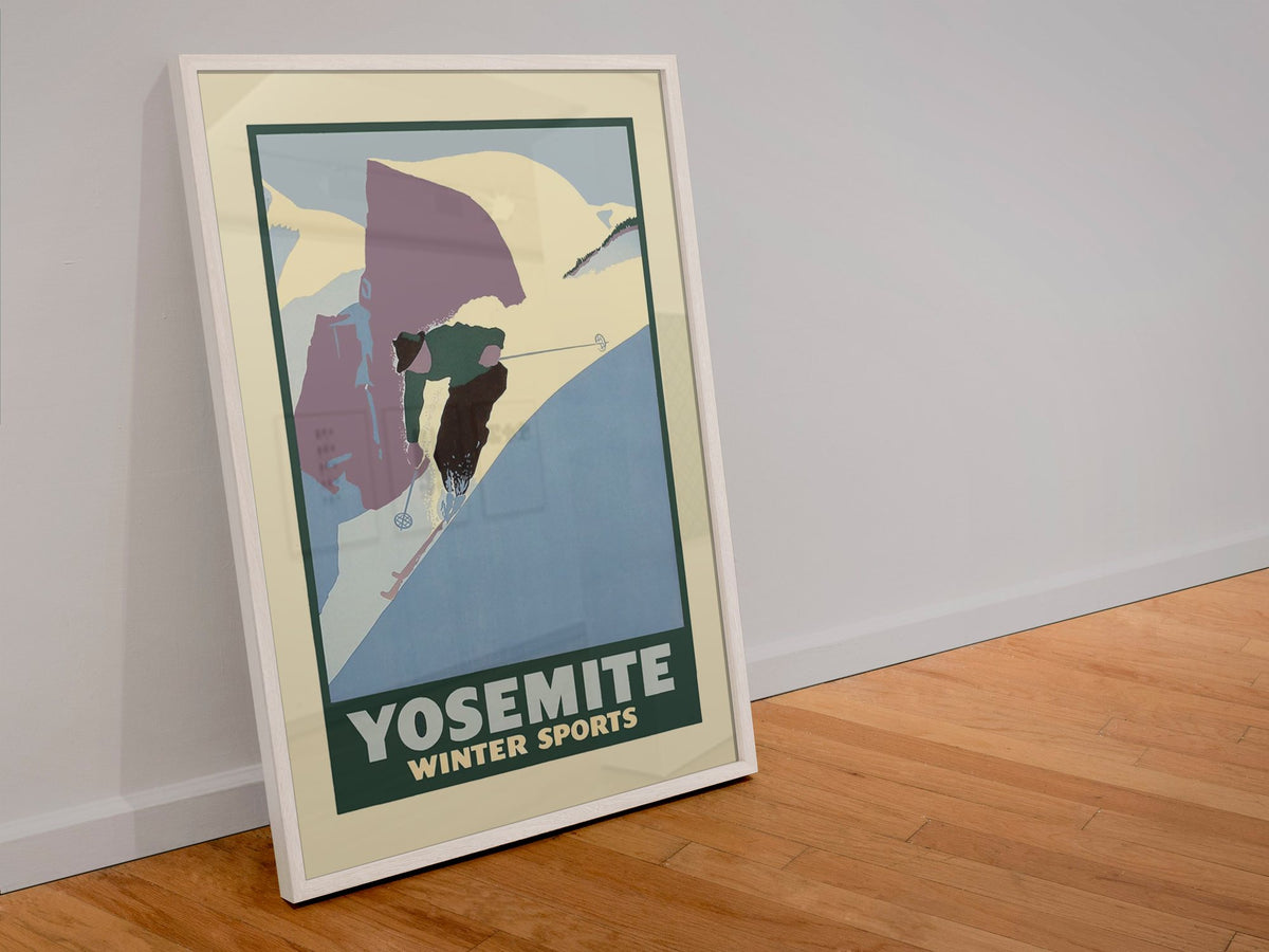 Yosemite Winter Sports Half Dome poster in a white frame leaning against a wall