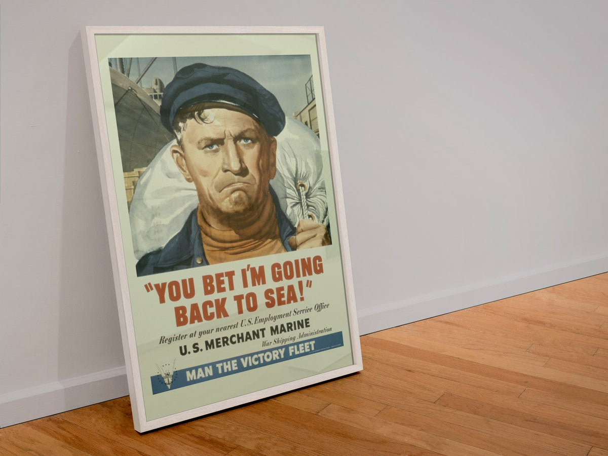 You Bet Im Going Back to Sea Merchant Marine poster in a white frame leaning against a wall
