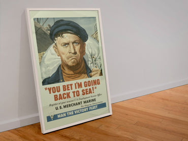 You Bet Im Going Back to Sea Merchant Marine poster in a white frame leaning against a wall