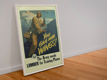 You Give Him Wings — Lumber for Training Planes poster in a white frame leaning against a wall