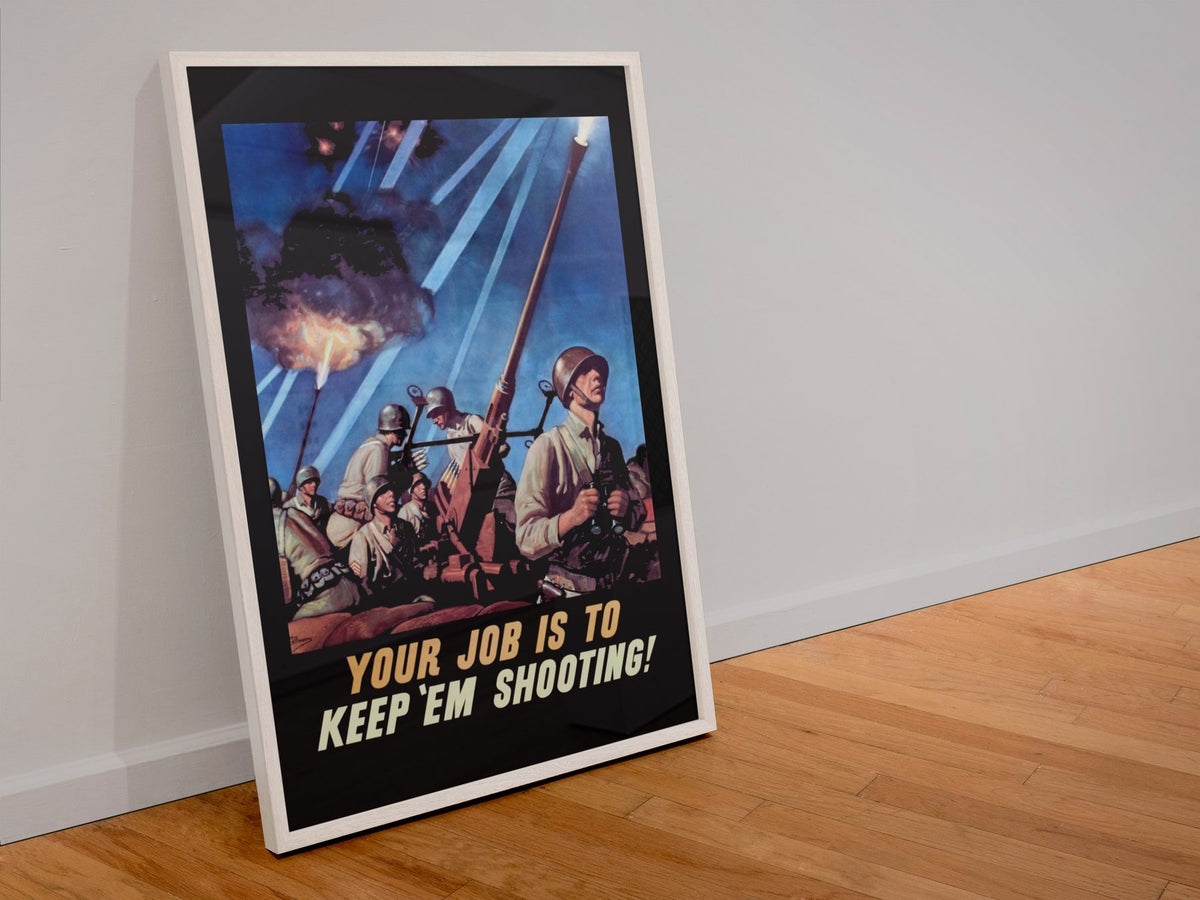 Your Job Is to Keep Em Shooting poster in a white frame leaning against a wall