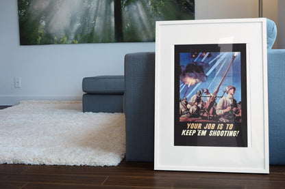 Your Job Is to Keep Em Shooting poster leaning beside a blue sofa