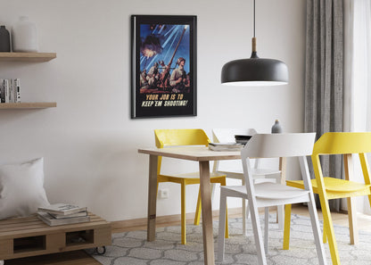 Your Job Is to Keep Em Shooting poster framed above a dining table