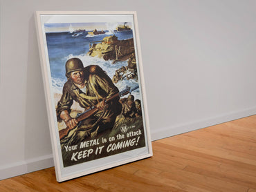 Your Metal Is on the Attack Keep It Coming poster in a white frame leaning against a wall