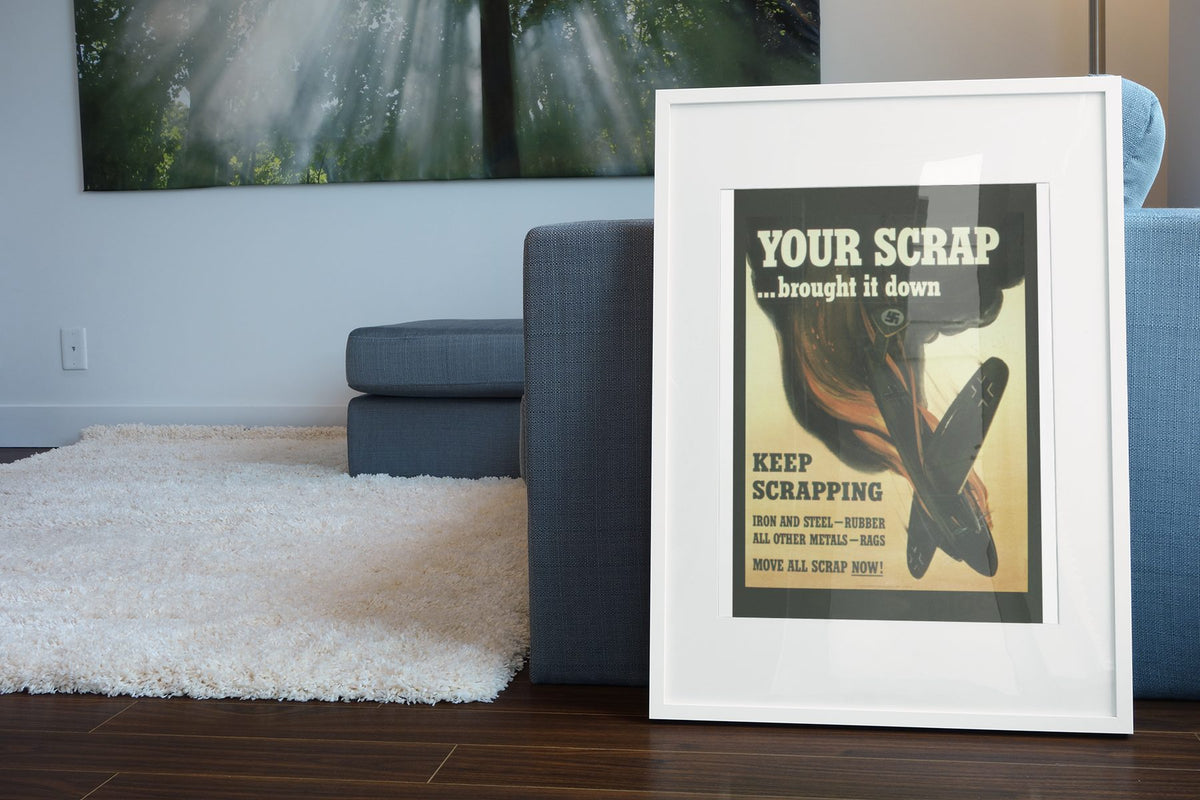 Your Scrap Brought It Down poster leaning beside a blue sofa
