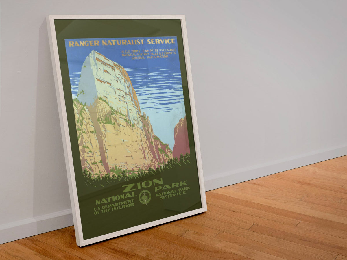 Zion National Park poster in a white frame leaning against a wall
