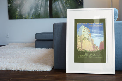 Zion National Park poster leaning beside a blue sofa
